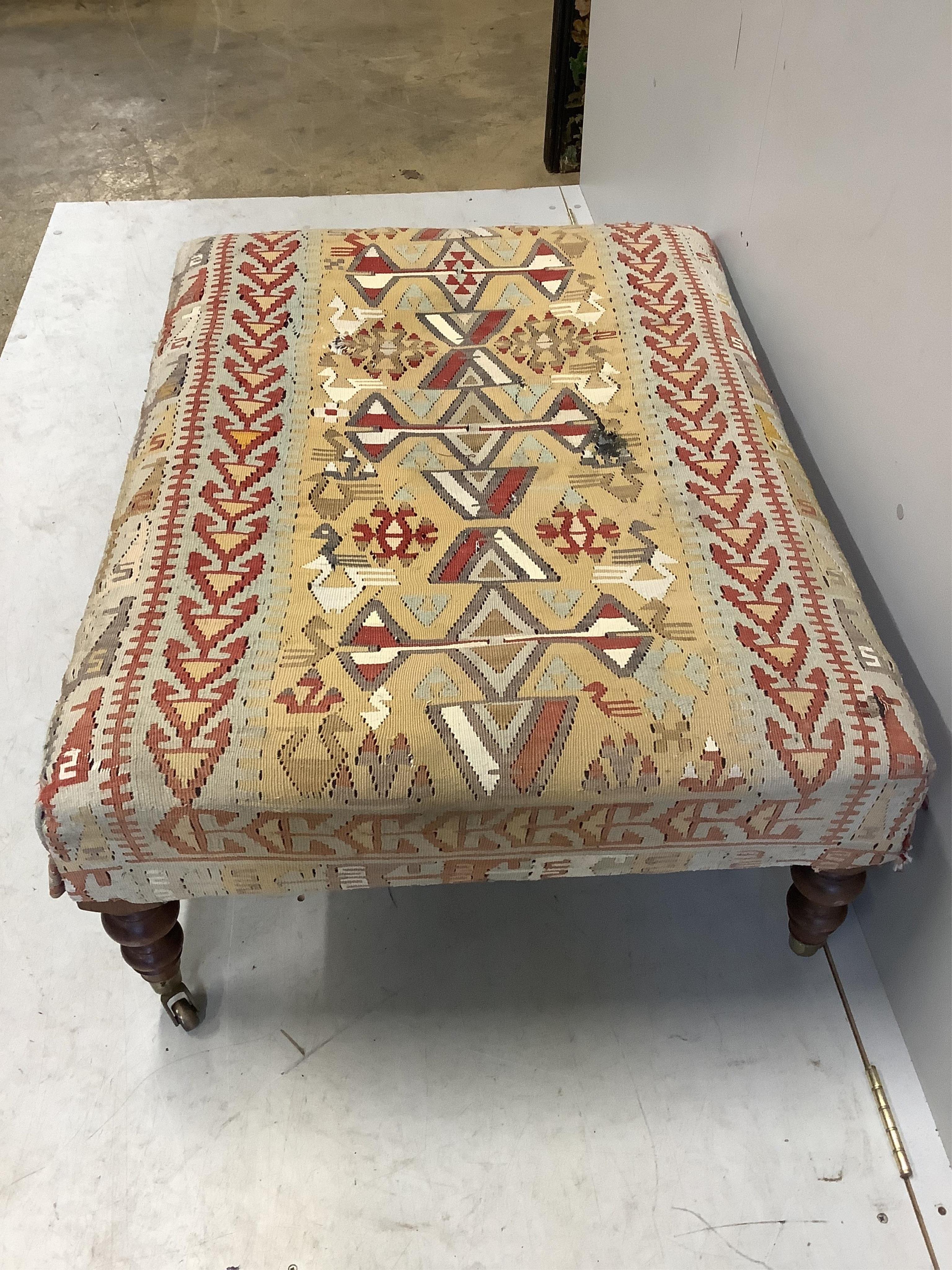 A rectangular Victorian style footstool with Kilim upholstery, width 102cm, depth 76cm, height 41cm. Condition - poor to fair